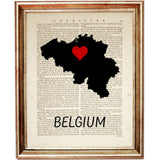 Silhouette map of Belgium with a red heart at the center, printed over a vintage book page with 'BELGIUM' written below